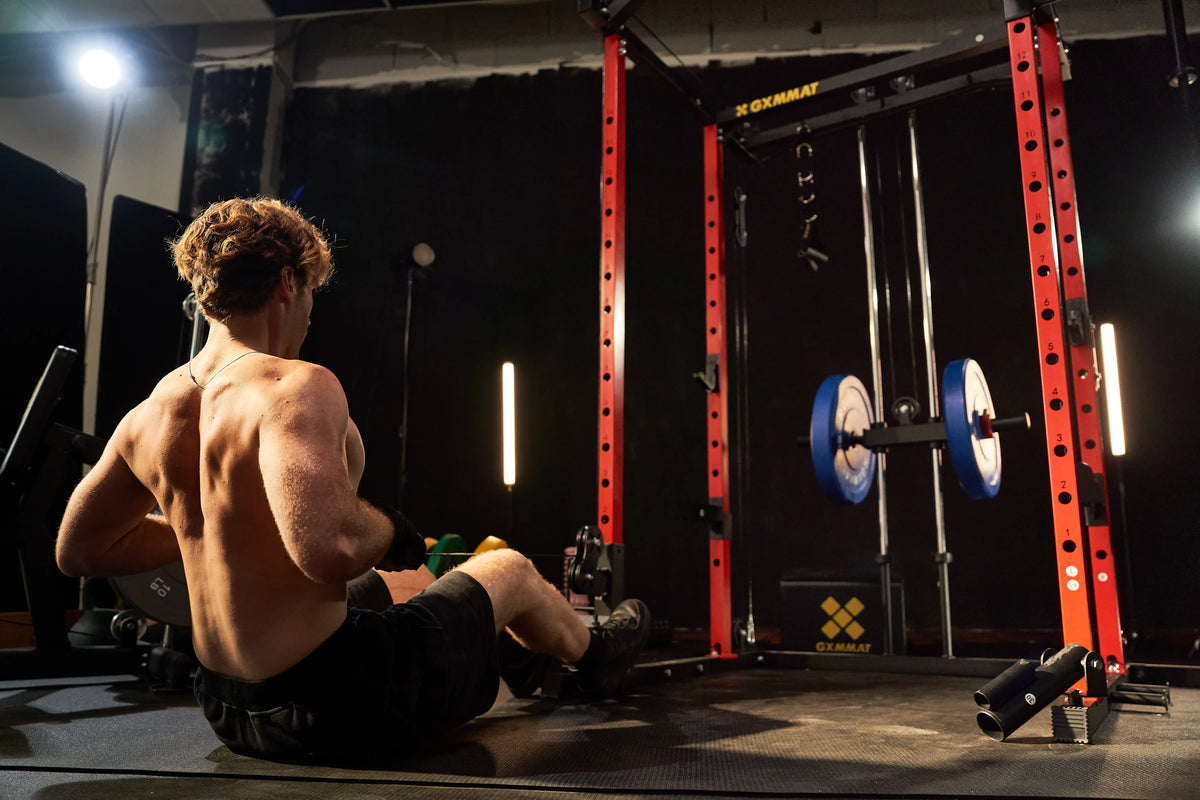 Athlete training hard on a red GXMMAT V6 power rack