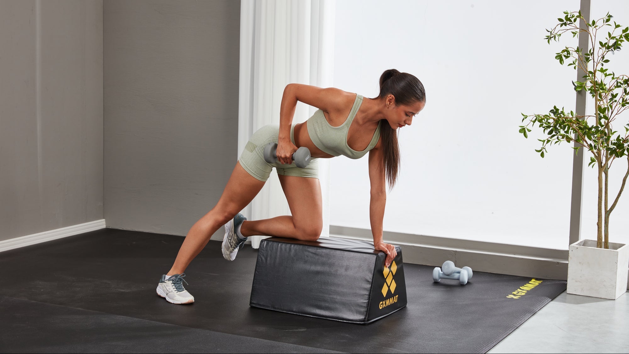 A Girl Doing Dumbbell Row on Glute Bench