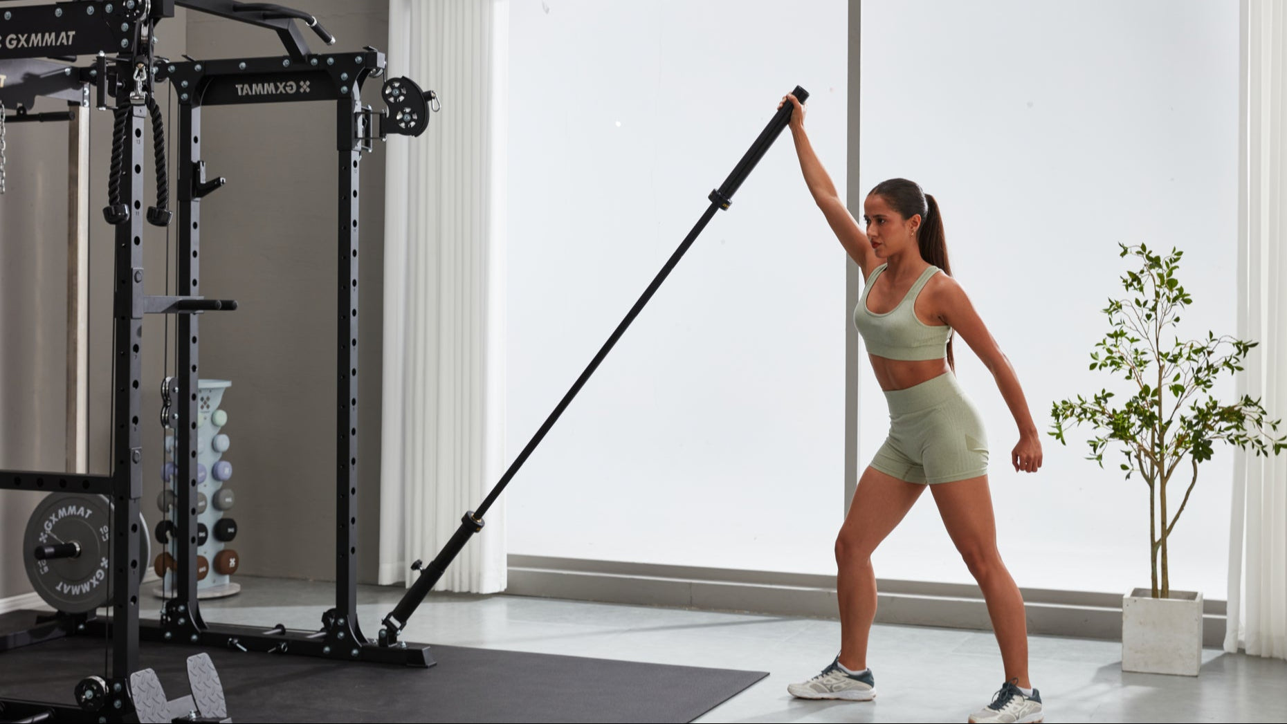 A Girl Doing Landmine Press with An Olympic Bar