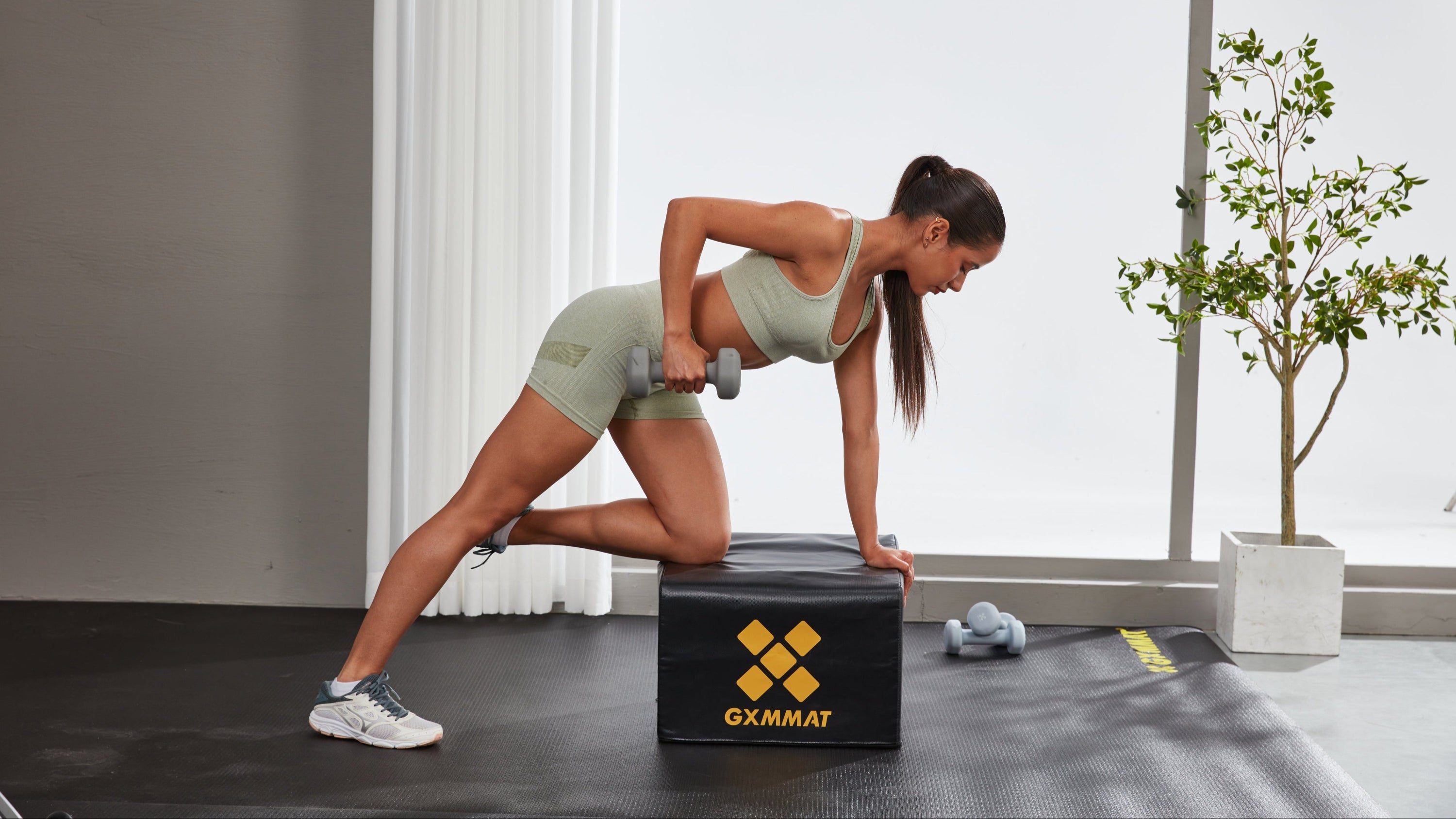 A Girl Doing Dumbbell Row on Hip Thrust Bench